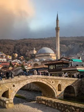 Historic bridge and mosque at sunset